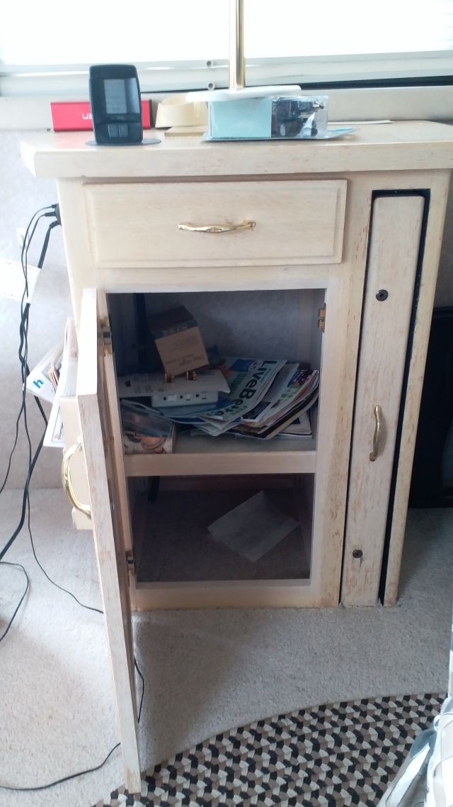 The fireplace replaced the cabinet which had been located immediately behind the passenger seat.  The size of the fireplace was similar to that of the cabinet.  There were two electrical boxes that came into the cabinet, and they were preserved and attached in the space between the bottom of the fireplace and the floor.